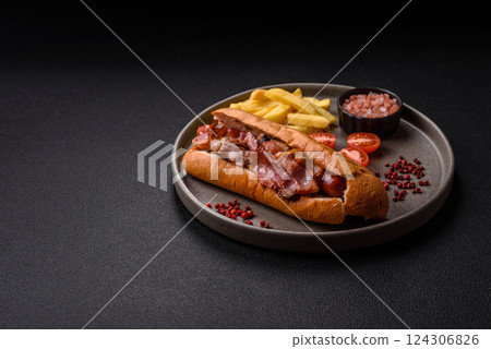 Delicious juicy hot dog with sausage, bacon, sauce, salt and spices 124306826