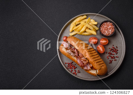 Delicious juicy hot dog with sausage, bacon, sauce, salt and spices 124306827