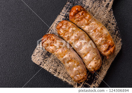 Juicy chicken or pork sausages with salt and spices Juicy chicken or pork sausages with salt and spices 124306894