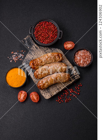 Juicy chicken or pork sausages with salt and spices 124306902