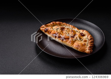 Cheburek meat pastry pie with herbs on the concrete background 124306969