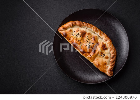 Cheburek meat pastry pie with herbs on the concrete background 124306970