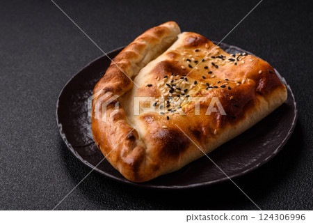 Cheburek meat pastry pie with herbs on the concrete background 124306996
