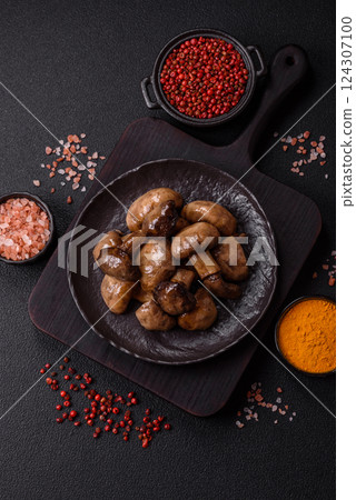 Grilled champignon mushrooms with salt, spices and herbs 124307100