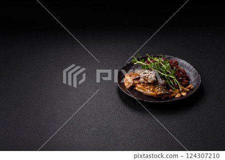 Grilled mackerel fillet pieces with vegetables, salt and spices 124307210