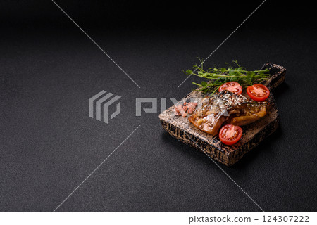 Grilled mackerel fillet pieces with vegetables, salt and spices 124307222