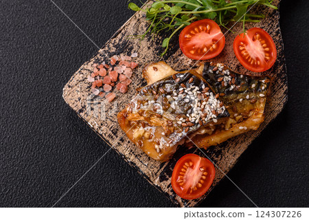 Grilled mackerel fillet pieces with vegetables, salt and spices Grilled mackerel fillet pieces with vegetables, salt and spices 124307226