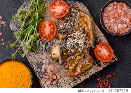 Grilled mackerel fillet pieces with vegetables, salt and spices Grilled mackerel fillet pieces with vegetables, salt and spices 124307229