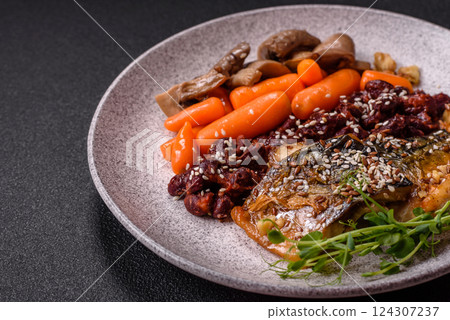 Grilled mackerel fillet pieces with vegetables, salt and spices Grilled mackerel fillet pieces with vegetables, salt and spices 124307237