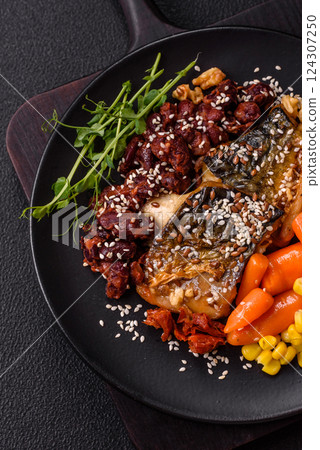 Grilled mackerel fillet pieces with vegetables, salt and spices Grilled mackerel fillet pieces with vegetables, salt and spices 124307250