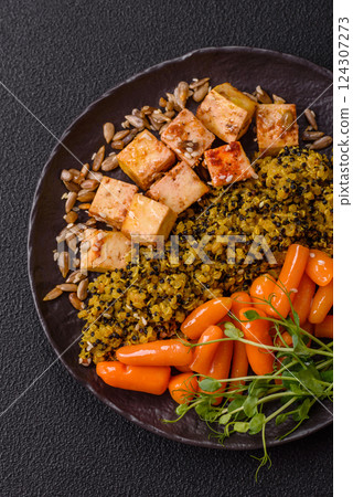 Quinoa bowl with tofu, steamed vegetables, grains, seeds and spices 124307273