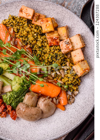 Quinoa bowl with tofu, steamed vegetables, grains, seeds and spices 124307288