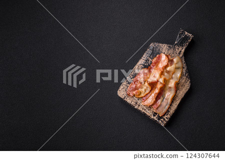 Delicious bacon in the form of slices with salt, spices and herbs 124307644