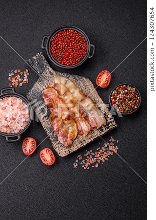 Delicious bacon in the form of slices with salt, spices and herbs 124307654