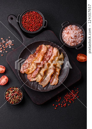 Delicious bacon in the form of slices with salt, spices and herbs 124307657