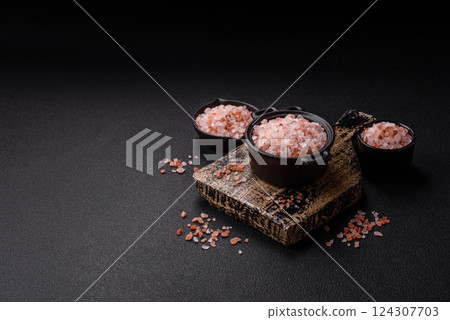 Pink himalayan salt in a black bowl on a dark concrete background Pink himalayan salt in a black bowl on a dark concrete background 124307703
