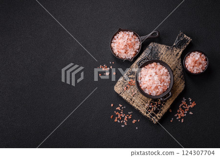 Pink himalayan salt in a black bowl on a dark concrete background Pink himalayan salt in a black bowl on a dark concrete background 124307704
