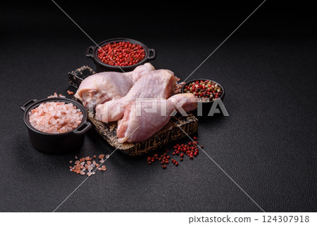 Raw chicken legs with salt, spices and herbs 124307918