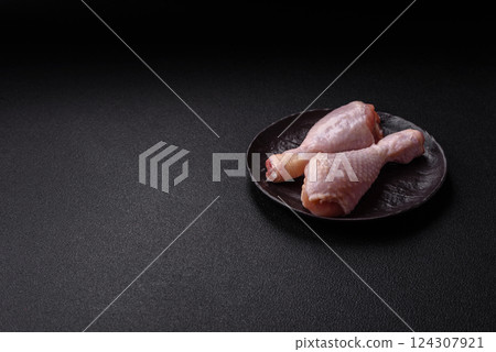 Raw chicken legs with salt, spices and herbs Raw chicken legs with salt, spices and herbs 124307921