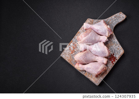 Raw chicken legs with salt, spices and herbs Raw chicken legs with salt, spices and herbs 124307935