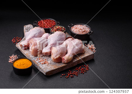Raw chicken legs with salt, spices and herbs Raw chicken legs with salt, spices and herbs 124307937