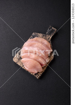 Fresh chicken fillet on a dark concrete table with spices and herbs 124308013