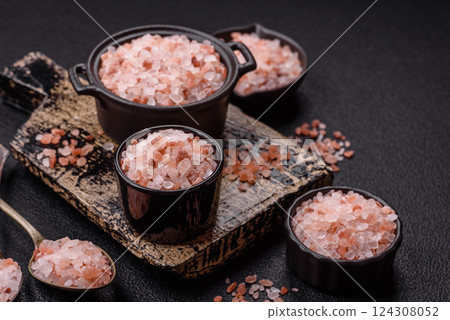 Pink himalayan salt in a black bowl on a dark concrete background Pink himalayan salt in a black bowl on a dark concrete background 124308052