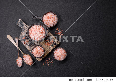 Pink himalayan salt in a black bowl on a dark concrete background Pink himalayan salt in a black bowl on a dark concrete background 124308056