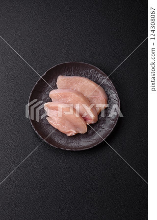 Fresh chicken fillet on a dark concrete table with spices and herbs 124308067
