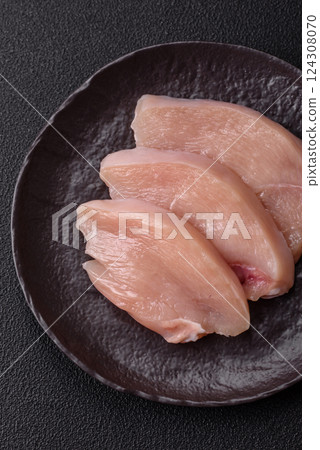Fresh chicken fillet on a dark concrete table with spices and herbs 124308070