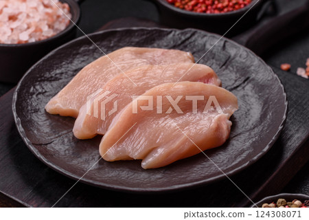 Fresh chicken fillet on a dark concrete table with spices and herbs 124308071