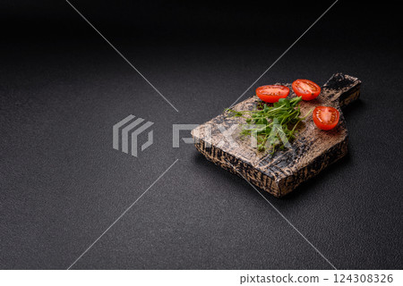 Sprigs of green fresh microgreen peas on wooden cutting board 124308326