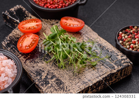 Sprigs of green fresh microgreen peas on wooden cutting board Sprigs of green fresh microgreen peas on wooden cutting board 124308331