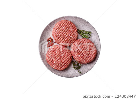 Fresh raw ground beef burger patty with salt and spices 124308447
