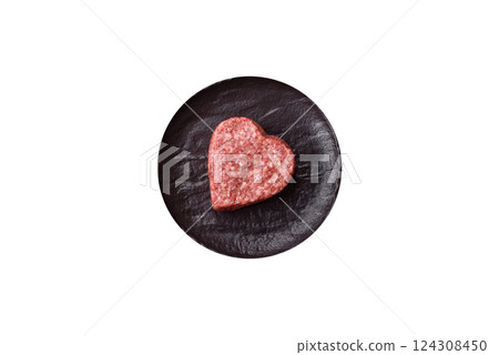 Raw beef or pork burger patty in the shape of a heart Raw beef or pork burger patty in the shape of a heart 124308450