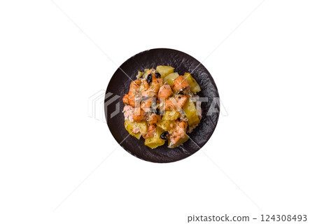 Baked salmon pieces with potatoes, cheese and olives 124308493