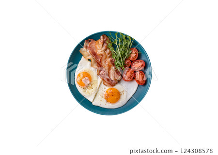 A hearty breakfast with fried eggs, bacon, tomatoes, microgreens 124308578