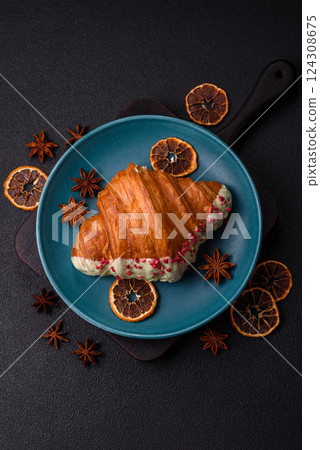 Crispy sweet red croissant with pistachio, raspberry and strawberry 124308675