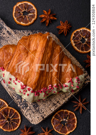 Crispy sweet red croissant with pistachio, raspberry and strawberry 124308684