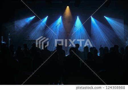 Concert performance illuminated by striking blue lights with a captured audience 124308988