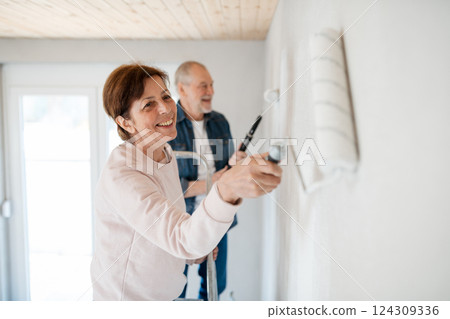 Senior couple renovating their home, a shared retirement activity. Senior couple renovating their home, a shared retirement activity. 124309336