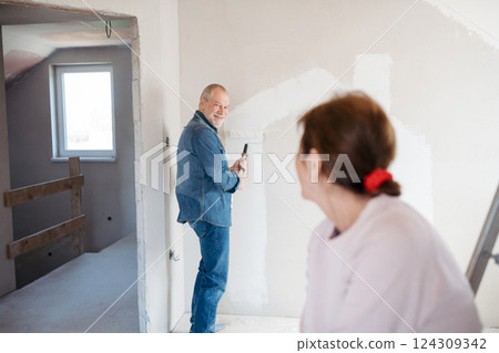 Senior couple renovating their home, a shared retirement activity. 124309342