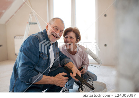 Senior couple renovating their home, a shared retirement activity. Senior couple renovating their home, a shared retirement activity. 124309397