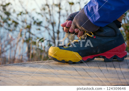 Tying the laces of hiking boots Tying the laces of hiking boots 124309646