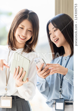 兩位女士/女商人使用平板電腦和智慧型手機開會 124309753