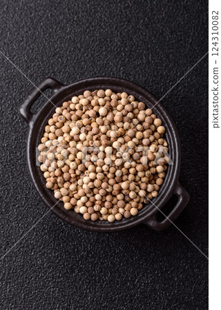 White allspice in a ceramic bowl 124310082