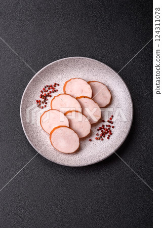 Delicious fresh ham cut into round slices with salt, spices and herbs 124311078