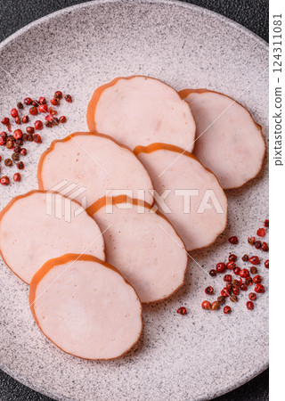 Delicious fresh ham cut into round slices with salt, spices and herbs 124311081
