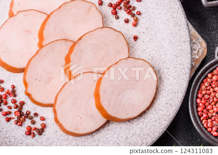 Delicious fresh ham cut into round slices with salt, spices and herbs 124311083