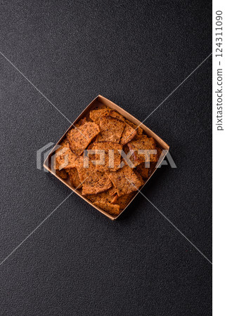 Crispy homemade brown bread chips with seeds and grains Crispy homemade brown bread chips with seeds and grains 124311090